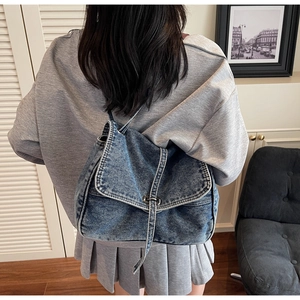Retro washed denim crossbody bag featuring white contrast stitching and metal clasp