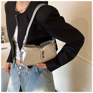 Detail of silver wavy glitter hobo bag with adjustable strap and metal twist lock