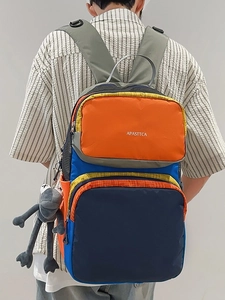 Large colorful patchwork backpack with blue and orange panels for travel and school