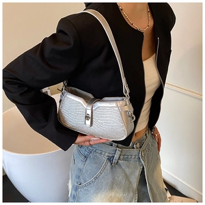Detail of silver glitter underarm bag with wavy texture and metallic clasp