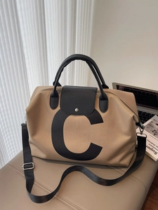 Minimalist large khaki canvas tote bag with black leather accents and C letter print
