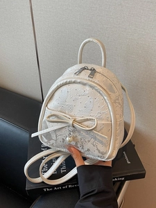 Mini pearl white backpack with butterfly print, ribbon bow, and pearl charm detail
