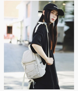 Outdoor street view of a lightweight urban backpack with cross bungee cord system