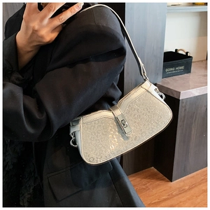 Detailed view of silver sequin shoulder bag with leopard texture on a female model