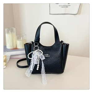 Detail of black cracked leather bucket bag with pearl lace bow and COIN 7ND2 logo