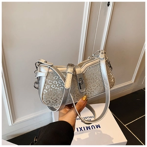 Detail of silver sequin bucket bag with leopard embossing and metallic twist lock