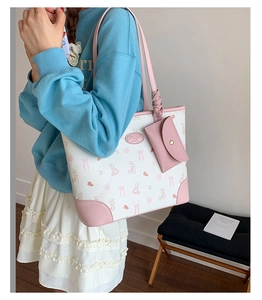 Detail of printed tote bag with pink rabbit pattern and detachable mini coin purse