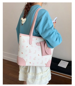 Detail of printed tote bag with matching pouch and cartoon rabbit motifs for women