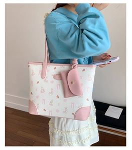 Detail of pink and white tote bag set with cute rabbit prints and matching coin purse