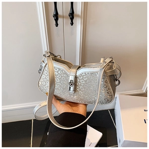 Detailed macro view of sparkling silver sequin bucket bag with leopard pattern texture