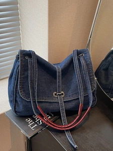 Vintage denim shoulder bag with silver twist lock and burgundy handle detail