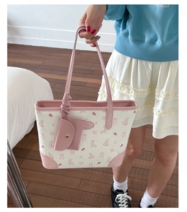 Detail of pink floral tote bag with cute rabbit pattern and matching mini coin purse