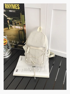Detail of off-white nylon backpack with elastic drawstring and breathable mesh back padding