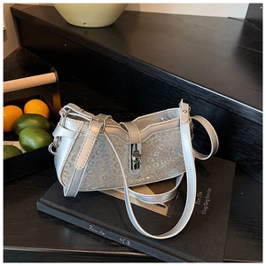 Close-up of silver leopard print sequins and metallic twist lock on the shoulder bag