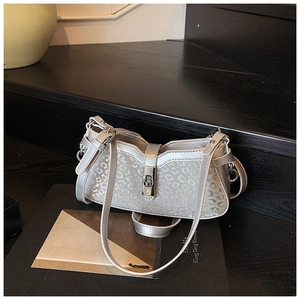 Detail of silver leopard pattern handbag with glitter finish and metallic twist lock