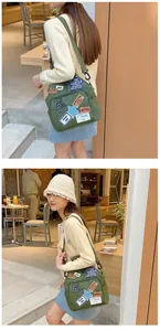 Nahaufnahme der armeegrünen Canvas-Tasche mit Vintage-Stickereien und festem Gurtband