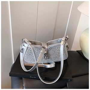Detail of silver leopard-embossed bucket bag with metallic finish and hardware buckle