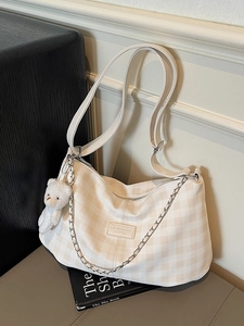 Plaid canvas shoulder bag in cream white with adjustable strap and bear pendant