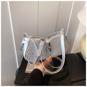 Detailed view of silver leopard print sequins and metallic buckle on the bucket bag