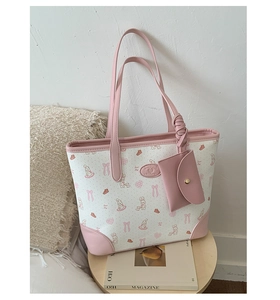 Detail view of large tote bag set with cute cartoon rabbit print and pink leather trim