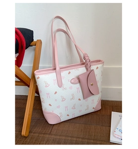 Close-up of pink and white tote bag featuring sweet rabbit prints and matching coin purse