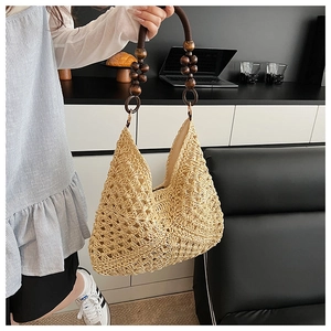 Detailed shot of straw tote bag featuring vintage dark brown wooden bead handles