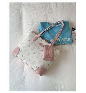 Detail view of pink rabbit printed tote bag set with matching small hanging pouch