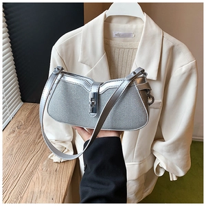 Detail of silver crescent shoulder bag with shimmering rhinestone mesh and metal buckle
