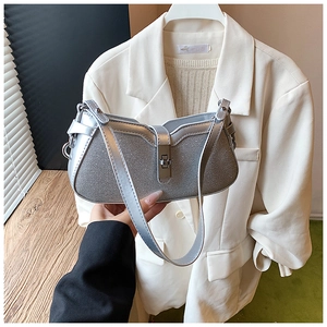 Detail of silver glitter shoulder bag with metallic buckle and curved crescent shape