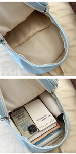 Detail view of light blue backpack interior showing spacious compartments and storage capacity
