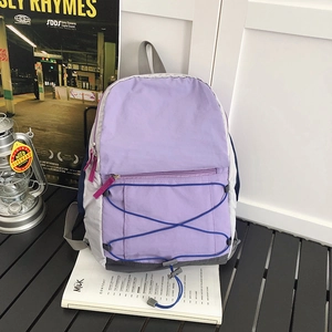 Lightweight lavender and grey outdoor sports backpack with blue elastic cord and pink zip pull