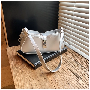 Detail view of the silver PU leather shoulder bag with sleek lock buckle and strap