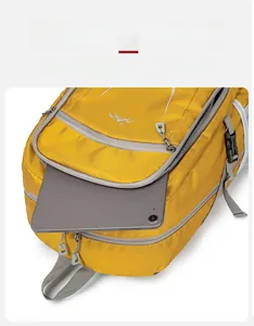 Detail view of yellow hiking backpack featuring tear-resistant fabric and tablet compartment