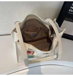 Close-up of the spacious interior with zippered pocket and NOROMORO brand label inside the bag