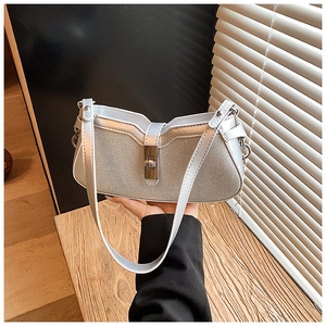 Detail of silver glitter underarm bag featuring shimmering sequins and metal clasp closure