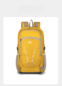 Front detail of yellow 40L outdoor backpack showing waterproof grid fabric and mountain logo