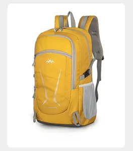 Detail of 40L yellow waterproof hiking backpack showing mesh pockets and durable nylon fabric