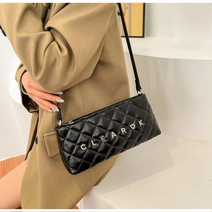 Detail of black quilted leather shoulder bag with crystal CLEAR letter logo decoration