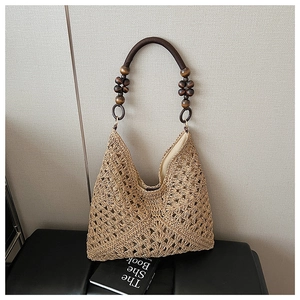 Detail of hand-woven straw tote with vintage wooden beads handle and textile lining