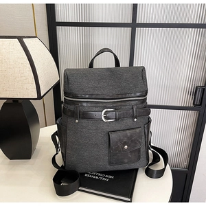 Detailed view of grey tweed texture and black leather strap on a versatile backpack