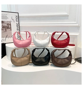 Six colors of lychee grain crescent crossbody bags displayed with elegant French decor
