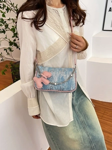 Blue sequin crossbody bag with pink trim, metal chain, and cute puppy charm detail