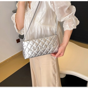 Close-up of silver quilted crossbody bag with CLEAROK text and heart detail