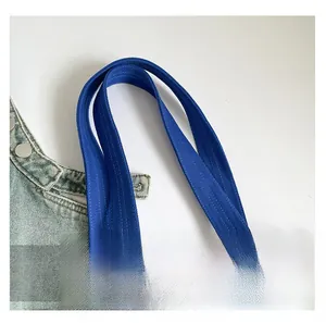 Close-up of deep blue canvas tote bag showing reinforced stitching and durable texture