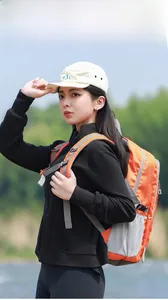 Close-up of orange outdoor backpack with grey mesh side pockets and adjustable straps