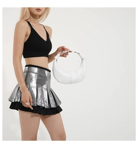 Detailed side view of a white hobo bag with a silver chain handle on a model