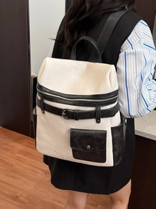 Fashionable beige and black large capacity backpack shown on model for daily commuting