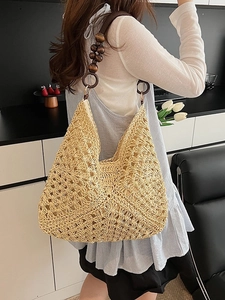 Handmade woven straw tote bag with decorative wooden beads and hollow knit patterns