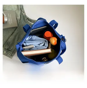Top view of spacious royal blue canvas tote bag showing interior storage for laptop and books