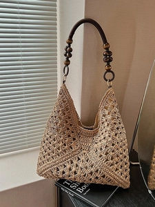 Handwoven straw tote bag with brown wooden beads handle for summer beach vacation